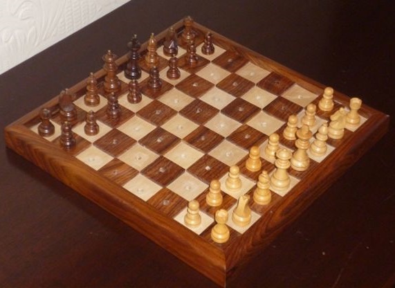 Photo of tactile chess set showing raised squares and adapted chess pieces