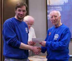 Phil Rafferty (left) receives his grading prize from Bill Armstrong