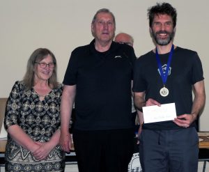 Ben Fletcher-Harris (R) received the 2026 Graham Lilley Award for the most improved rating from Jon and Maria Lilley