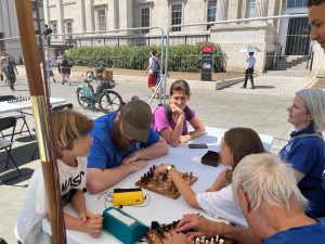 Bittor Ibanez (2nd L) took on some passers by at Chess Fest.